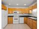 Functional kitchen featuring wooden cabinets, modern appliances, and tile flooring at 1217 Aqui Esta Dr # 5, Punta Gorda, FL 33950