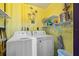Functional laundry room with washer, dryer, and shelving, making laundry chores efficient and organized at 1217 Aqui Esta Dr # 5, Punta Gorda, FL 33950