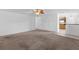 Inviting living room with neutral carpet, leading to the kitchen area at 1217 Aqui Esta Dr # 5, Punta Gorda, FL 33950