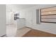 Bright living room featuring tile and carpet, and a large window that lets in natural light at 1217 Aqui Esta Dr # 5, Punta Gorda, FL 33950