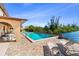 Pool with lounge chairs and seating with waterfront and landscaping at 1217 Aqui Esta Dr # 5, Punta Gorda, FL 33950