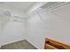 Spacious walk-in closet with ample shelving and carpeting at 1217 Aqui Esta Dr # 5, Punta Gorda, FL 33950
