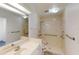 Bathroom with a shower, sink, and safety bars at 1351 Washington Dr, Englewood, FL 34224