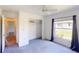 Carpeted bedroom with closet and window at 1351 Washington Dr, Englewood, FL 34224
