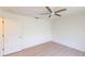 A clean, empty bedroom with wood-look flooring and plenty of sunlight at 1351 Washington Dr, Englewood, FL 34224