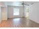 Bedroom features hardwood flooring, ceiling fan and attached bathroom at 1351 Washington Dr, Englewood, FL 34224