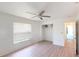 Bedroom with wood-look floors, ceiling fan, and closet at 1351 Washington Dr, Englewood, FL 34224