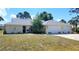 Charming ranch-style home featuring an attached three car garage, fresh landscaping, and a well-maintained lawn at 1351 Washington Dr, Englewood, FL 34224
