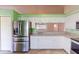 Bright kitchen features stainless steel appliances, granite counters, and white cabinets at 1351 Washington Dr, Englewood, FL 34224