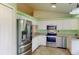 Modern kitchen with stainless steel appliances, white cabinetry, and granite countertops at 1351 Washington Dr, Englewood, FL 34224