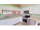 This kitchen offers stainless appliances, granite counters, and ample cabinet space at 1351 Washington Dr, Englewood, FL 34224