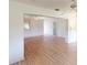 Open-concept living room with wood-look flooring and an arched doorway at 1351 Washington Dr, Englewood, FL 34224