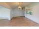 Bright open-concept living room features wood-look flooring and neutral walls at 1351 Washington Dr, Englewood, FL 34224