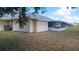 A sunny backyard with screened in porch, and an exterior AC unit for efficient climate control at 1351 Washington Dr, Englewood, FL 34224