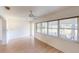 Bright sunroom featuring wood-look flooring, a ceiling fan and large windows at 1351 Washington Dr, Englewood, FL 34224