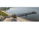 Aerial view of a long wooden pier and beach area with a lifeguard station and ocean views at 14459 River Beach Dr # 112, Port Charlotte, FL 33953