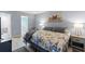 Comfortable bedroom shows a large bed, two side tables with lamps and an en-suite bathroom at 14459 River Beach Dr # 112, Port Charlotte, FL 33953