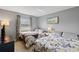 Bright bedroom featuring two beds, a window with curtains, and a relaxing ambiance at 14459 River Beach Dr # 112, Port Charlotte, FL 33953