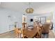 Charming dining area with wooden table and chairs, complemented by a stylish light fixture and view to the living room at 14459 River Beach Dr # 112, Port Charlotte, FL 33953