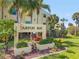Well-maintained entrance with palm trees and lush landscaping adds curb appeal to the complex at 14459 River Beach Dr # 112, Port Charlotte, FL 33953
