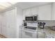 Fully equipped kitchen with stainless steel microwave and a well-maintained stove and oven combination, great for cooking at 14459 River Beach Dr # 112, Port Charlotte, FL 33953