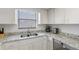 Clean kitchen featuring granite countertops, stainless sink and plenty of counter space for easy meal prep at 14459 River Beach Dr # 112, Port Charlotte, FL 33953