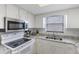 Well-lit kitchen boasts granite countertops, stainless steel appliances, and ample cabinet space for convenient cooking at 14459 River Beach Dr # 112, Port Charlotte, FL 33953