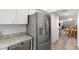Bright kitchen offers modern stainless steel refrigerator and dishwasher with easy access to the dining area at 14459 River Beach Dr # 112, Port Charlotte, FL 33953