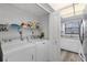 Modern laundry room features a washer and dryer, as well as some shelving for storage at 14459 River Beach Dr # 112, Port Charlotte, FL 33953