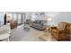 Cozy living room featuring comfortable seating, neutral color palette, and sliding glass doors to the balcony at 14459 River Beach Dr # 112, Port Charlotte, FL 33953