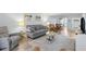 Open-concept living space with comfortable seating, modern décor, connecting the living and dining areas seamlessly at 14459 River Beach Dr # 112, Port Charlotte, FL 33953