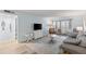 Bright living room with wood floors, gray sofa, recliner and view to balcony, seamlessly blending comfort and style at 14459 River Beach Dr # 112, Port Charlotte, FL 33953