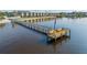 View of the pier with benches and an American flag, offering scenic waterfront relaxation at 14459 River Beach Dr # 112, Port Charlotte, FL 33953