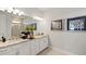 Well-lit bathroom with double sinks, granite countertops, and framed mirrors at 15968 Crofton Springs Way, Port Charlotte, FL 33953