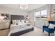 Serene bedroom featuring a tufted headboard, soft lighting, and a calming color palette at 15968 Crofton Springs Way, Port Charlotte, FL 33953
