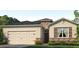 Charming single-story home featuring stone accents, a two-car garage, and a well-manicured lawn at 15968 Crofton Springs Way, Port Charlotte, FL 33953