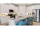Modern kitchen with white cabinetry, marble countertops, stainless steel appliances, and seating at the island at 15968 Crofton Springs Way, Port Charlotte, FL 33953