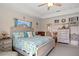 Coastal themed bedroom with tray ceiling and nautical decor at 16094 Ortega Dr, Punta Gorda, FL 33955