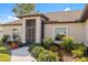 Inviting entrance with screen, well-lit walkway, and beautifully maintained garden at 16094 Ortega Dr, Punta Gorda, FL 33955