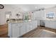 Bright kitchen featuring a large island with marble countertop, stainless steel appliances and wood-look flooring at 16094 Ortega Dr, Punta Gorda, FL 33955