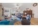 Comfortable living space with a leather sectional, hardwood floors, and bright lighting at 16094 Ortega Dr, Punta Gorda, FL 33955
