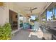 Screened patio offers a ceiling fan, a grill, and seating with a lovely view of the yard at 16094 Ortega Dr, Punta Gorda, FL 33955