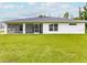 An exterior shot of the back of the home showcasing the lawn at 17130 Elder St, Port Charlotte, FL 33954