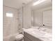 Bathroom featuring a tub with tile surround, a modern vanity, and a large mirror at 17130 Elder St, Port Charlotte, FL 33954