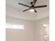 Modern ceiling fan in bedroom with tray ceiling and windows at 17130 Elder St, Port Charlotte, FL 33954