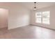 Bright bedroom with hardwood floors, natural light and a modern pendant light fixture at 17130 Elder St, Port Charlotte, FL 33954