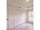 Bright bedroom featuring a closet with paneled doors and a window with natural light at 17130 Elder St, Port Charlotte, FL 33954