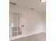 Bedroom featuring a door with glass panes and light wood flooring at 17130 Elder St, Port Charlotte, FL 33954