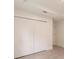 Bedroom featuring a closet with paneled doors and light wood flooring at 17130 Elder St, Port Charlotte, FL 33954
