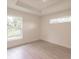 Bedroom with two windows offering a view of the outdoors and stylish hardwood floors at 17130 Elder St, Port Charlotte, FL 33954